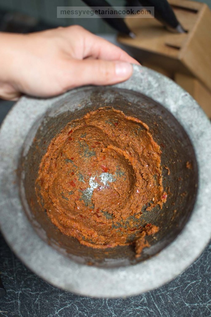 Making curry paste in a granite mortar.