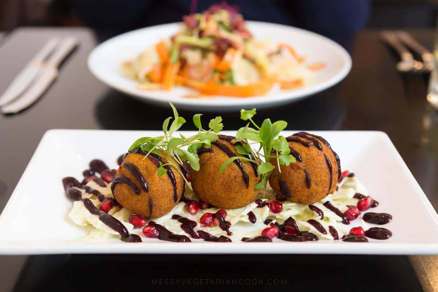 Plantain fritters filled with carrot, sultanas, mint and pine nuts served with chipotle and blueberry sauce and crispy fennel and pomegranate salad.