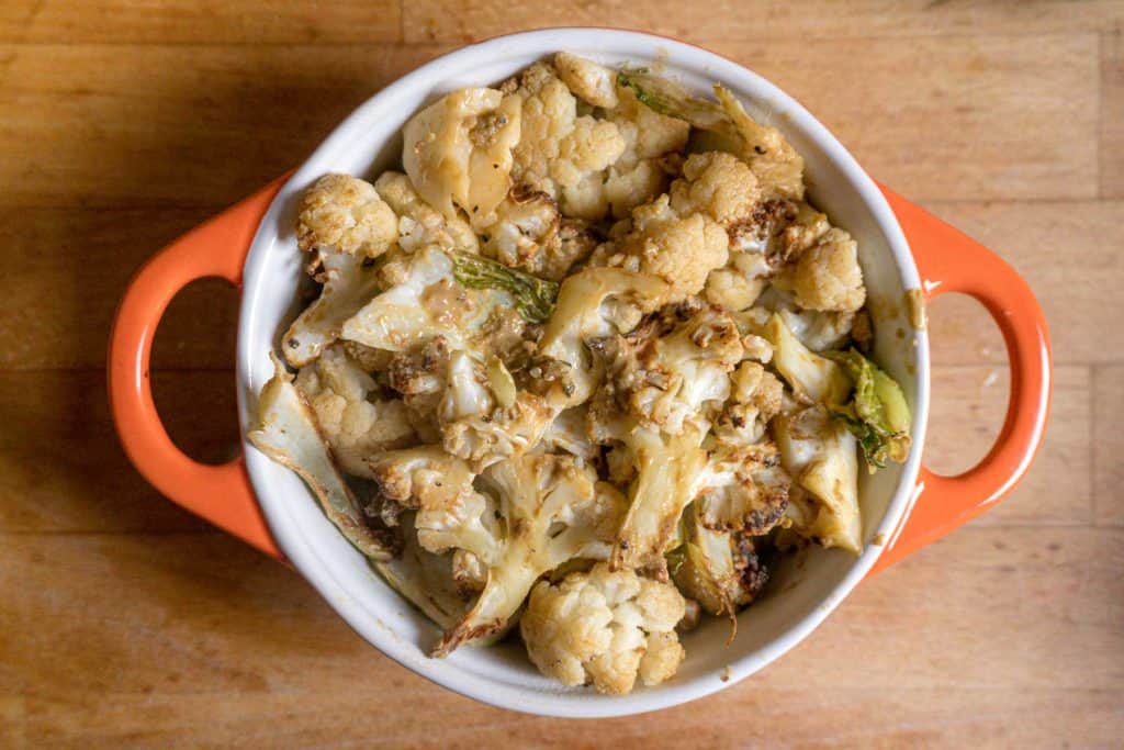 roasted cauliflower mixed with Chinkiang vinegar and nutritional yeast, placed in an ovenproof dish