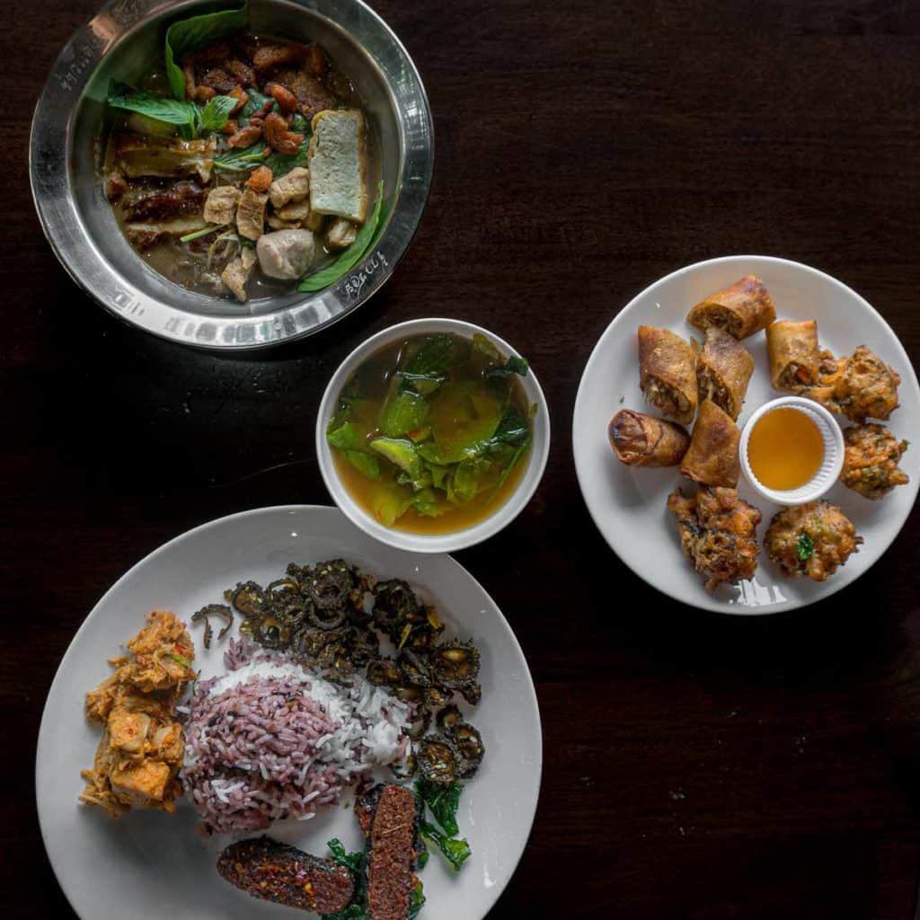 Boat noodles, stir fried fish in red curry paste, crispy bitter melon and more from Khao Daeng Gaeng Ron vegan restaurant in Bangkok